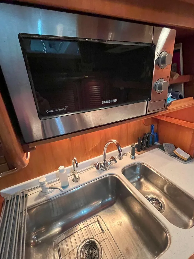 Slide: The Image of Hinckley Sou'wester 59 CC 2001 yacht kitchen with Samsung microwave and double sink. - 37