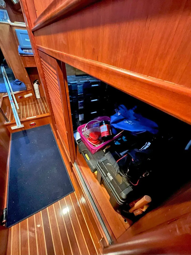 Slide: The Image of Interior storage area of 2001 Hinckley Sou'wester 59 CC sailboat with wooden finish. - 48