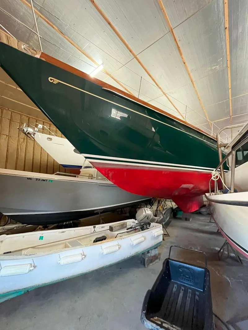 Slide: The Image of 2001 Hinckley Sou'wester 59 CC sailboat in storage, showcasing its sleek design and vibrant colors. - 22