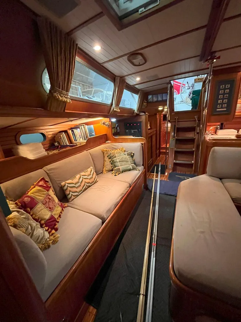 Slide: The Image of Interior of 2001 Hinckley Sou'wester 59 CC yacht with cozy seating and wooden finishes. - 24