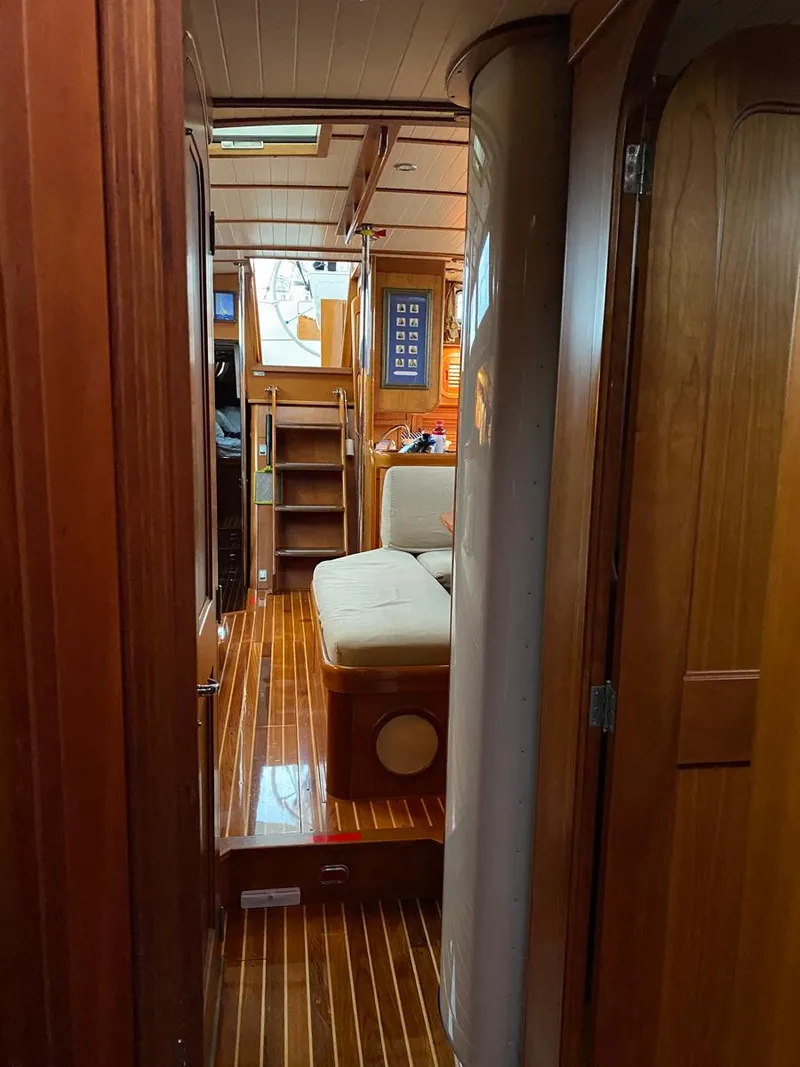 Slide: The Image of Interior of 2001 Hinckley Sou'wester 59 CC yacht with wooden flooring and seating area. - 27