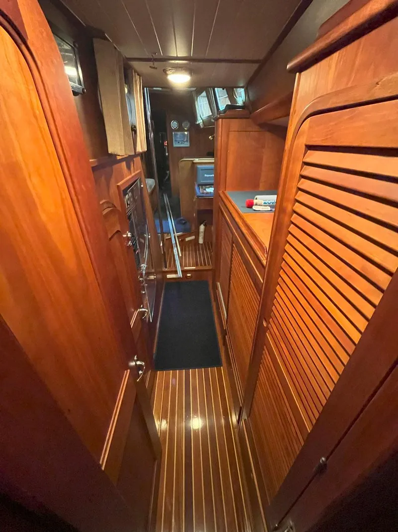 Slide: The Image of Interior of 2001 Hinckley Sou'wester 59 CC yacht with wooden paneling and flooring. - 28