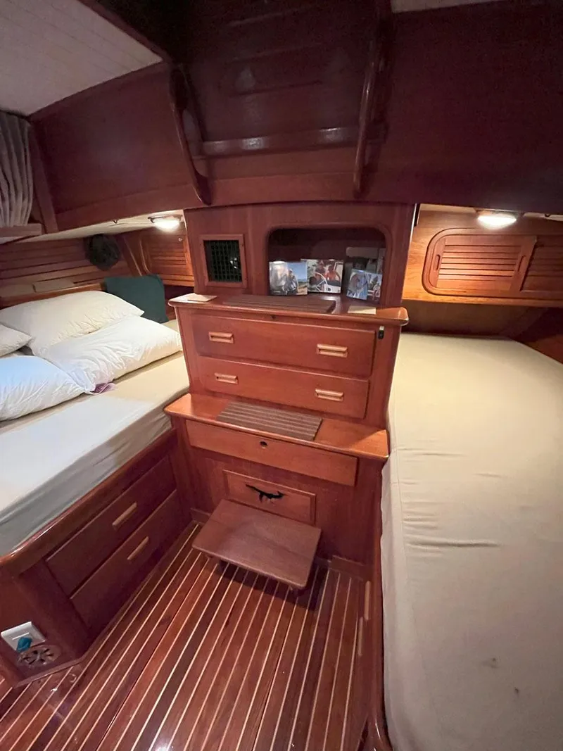 Slide: The Image of Interior of 2001 Hinckley Sou'wester 59 CC yacht with wooden cabinetry and twin beds. - 38