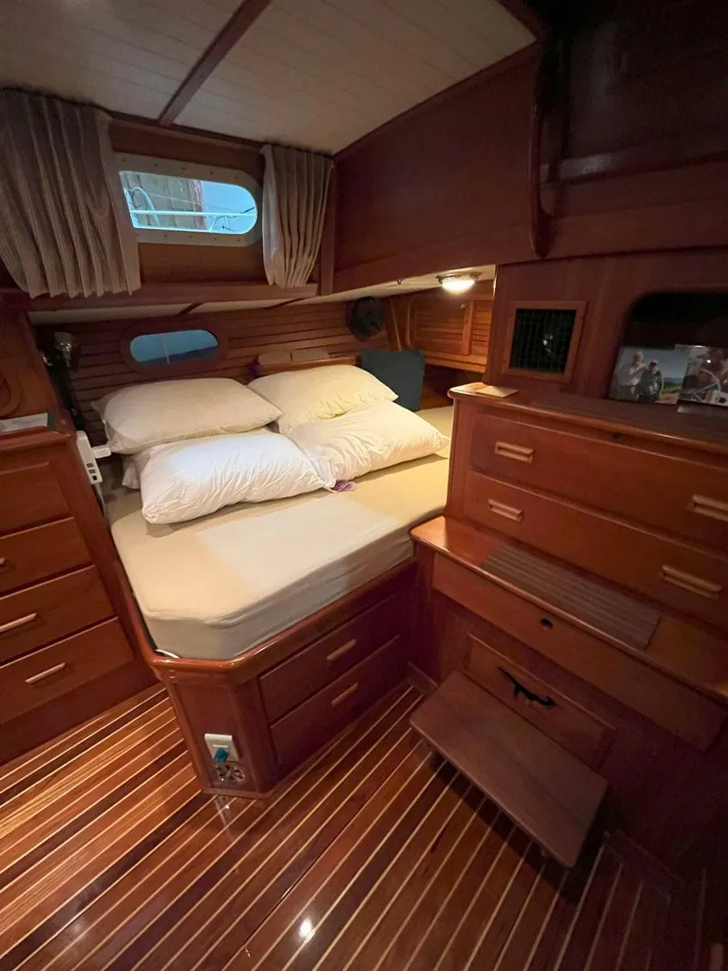 Slide: The Image of Luxurious cabin interior of 2001 Hinckley Sou'wester 59 CC sailboat with wooden furnishings. - 39