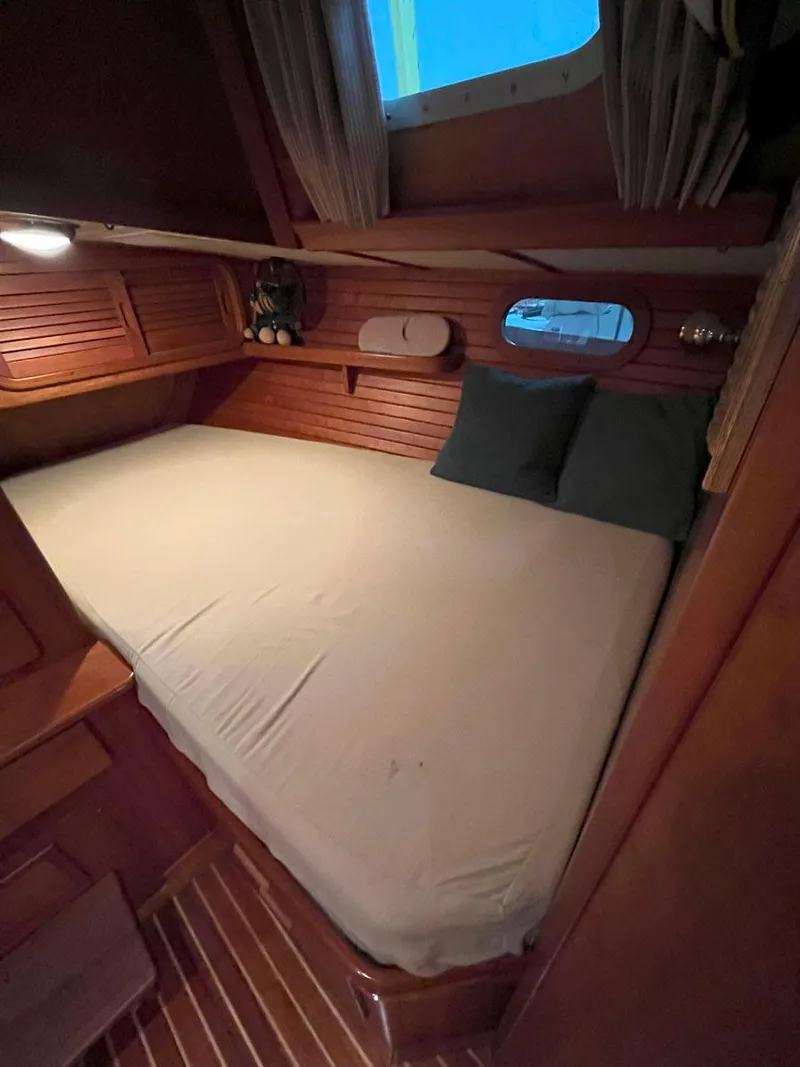 Slide: The Image of Cozy cabin interior of 2001 Hinckley Sou'wester 59 CC sailboat with wooden paneling. - 40