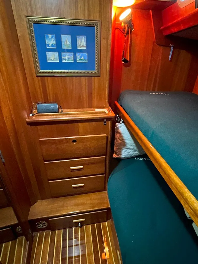 Slide: The Image of Cozy cabin interior of 2001 Hinckley Sou'wester 59 CC with wooden furnishings and bunk bed. - 44