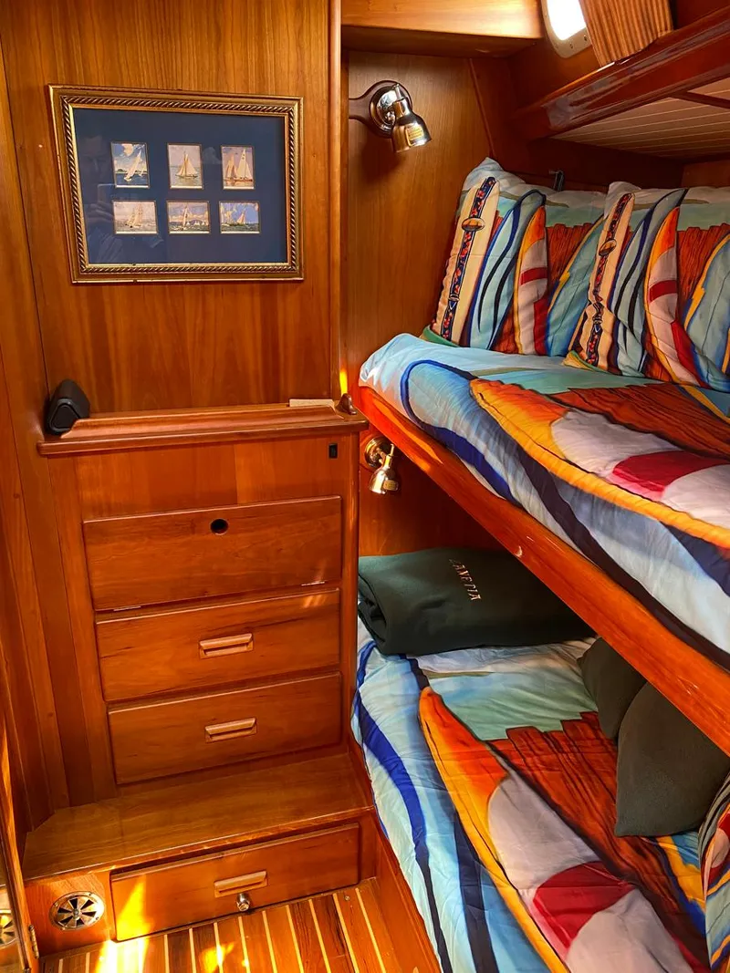 Slide: The Image of Cozy cabin interior of 2001 Hinckley Sou'wester 59 CC with vibrant bedding and wooden furnishings. - 47