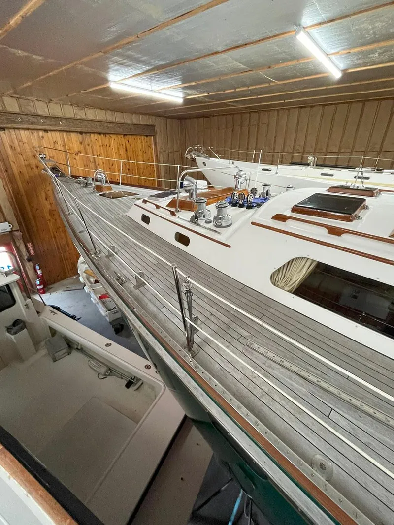 Slide: The Image of Hinckley Sou'wester 59 CC 2001 sailboat in indoor storage, showcasing deck and cabin features. - 9