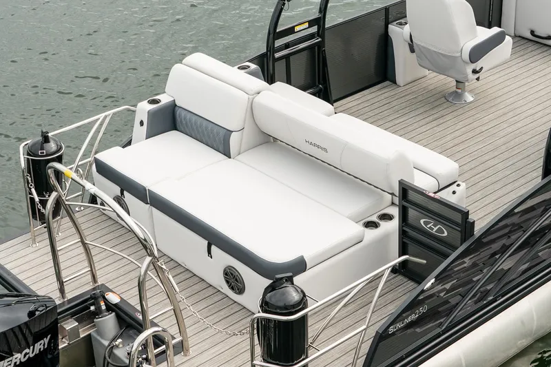 Slide: The Image of 2023 Harris 250 Sunliner Sport boat with spacious seating on water. - 10