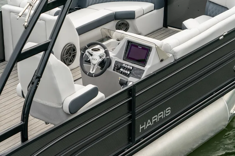 Slide: The Image of 2023 Harris 250 Sunliner Sport boat interior with modern helm and seating. - 11