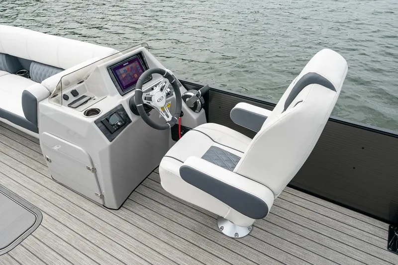 Slide: The Image of 2023 Harris 250 Sunliner Sport boat interior with steering console and captain's chair. - 14