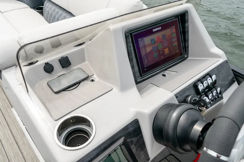 Slide: The Image of 2023 Harris 250 Sunliner Sport dashboard with touchscreen display and controls. - 17