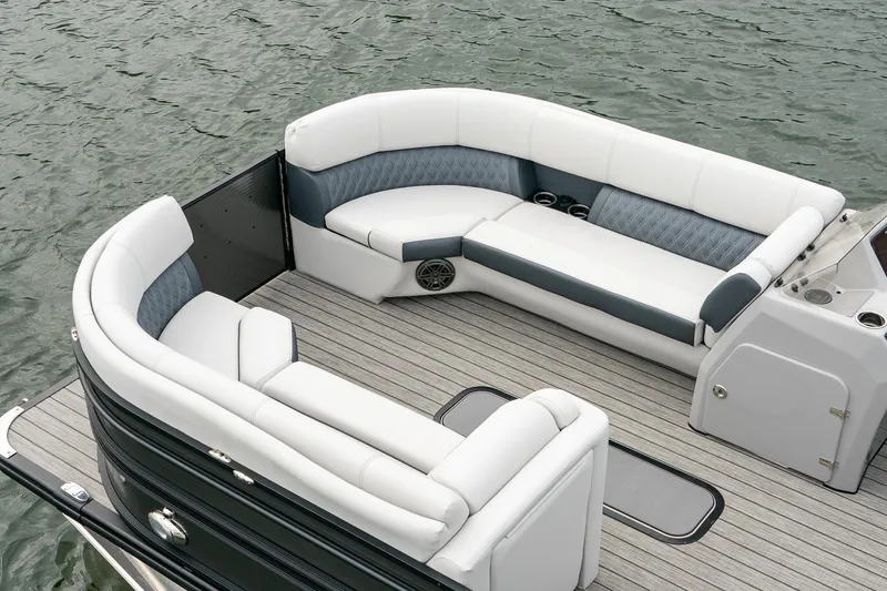 Slide: The Image of 2023 Harris 250 Sunliner Sport pontoon boat with luxurious seating on calm water. - 18