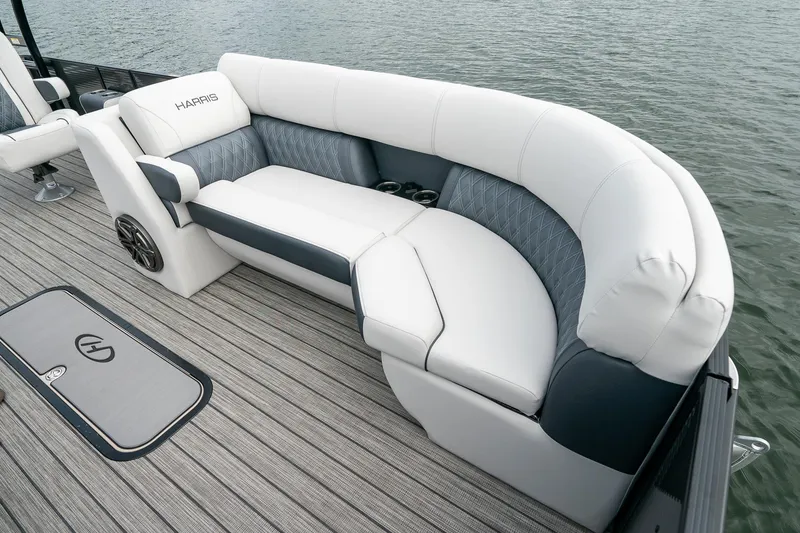 Slide: The Image of 2023 Harris 250 Sunliner Sport boat with luxurious seating on the water. - 21
