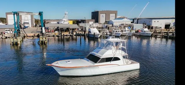 The Image of 1984 Custom Carolina Buddy Davis boat named Full Circle cruising in a marina. - 0