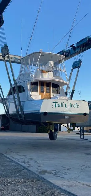 Slide: The Image of 1984 Custom Carolina Buddy Davis boat cruising in a marina at sunset. - 10