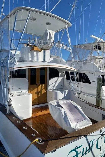 Slide: The Image of 1984 Custom Carolina Buddy Davis boat with fishing gear and wooden deck. - 14