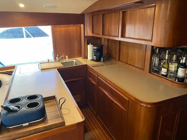 Slide: The Image of 1984 Custom Carolina Buddy Davis yacht kitchen with wooden cabinets and countertop. - 18