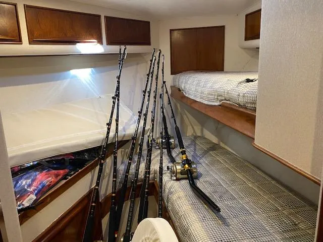 Slide: The Image of Interior of 1984 Custom Carolina Buddy Davis boat with fishing rods and bunk beds. - 24