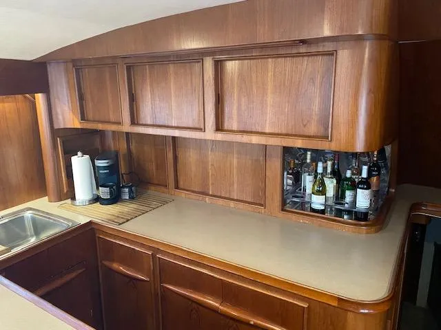 Slide: The Image of 1984 Custom Carolina Buddy Davis yacht kitchen with wooden cabinets and countertop. - 29