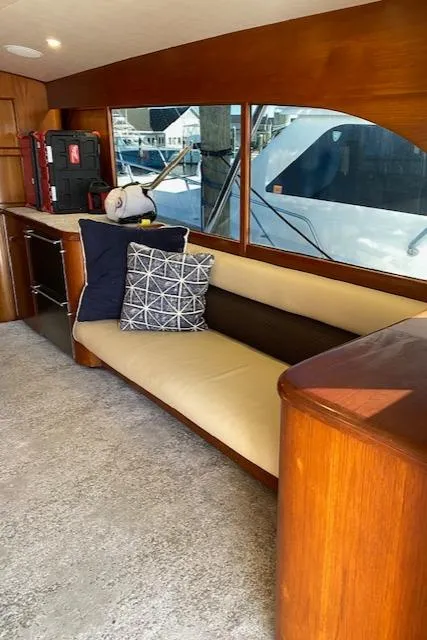 Slide: The Image of Interior of 1984 Custom Carolina Buddy Davis boat with beige seating and decorative pillows. - 30