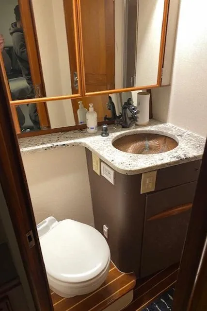 Slide: The Image of 1984 Custom Carolina Buddy Davis boat bathroom with granite countertop and wooden accents. - 36