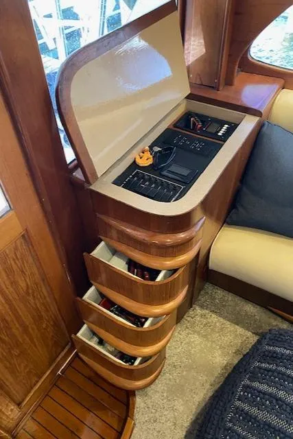 Slide: The Image of 1984 Custom Carolina Buddy Davis boat interior with open storage drawers and control panel. - 38