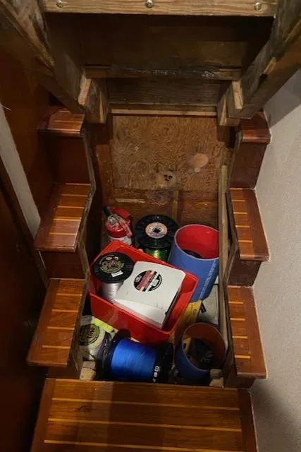 Slide: The Image of 1984 Custom Carolina Buddy Davis boat storage area with fishing gear and supplies. - 40