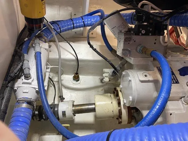 Slide: The Image of Engine room of a 1984 Custom Carolina Buddy Davis boat with blue hoses and mechanical components. - 44
