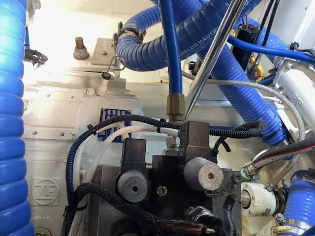 Slide: The Image of Engine compartment of a 1984 Custom Carolina Buddy Davis boat with blue hoses. - 45