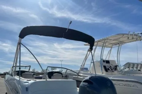 Slide: The Image of 2018 Hurricane SunDeck 2200 DC OB boat with bimini top under a clear sky. - 2