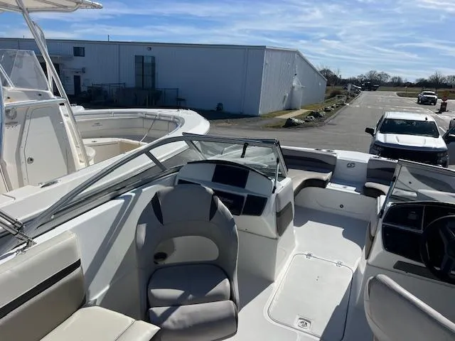 Slide: The Image of 2018 Hurricane SunDeck 2200 DC OB boat interior with seating and dashboard. - 5