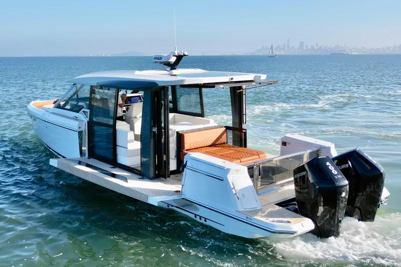 Slide: The Image of 2026 Saxdor 400 GTC luxury boat cruising on open water with city skyline. - 12