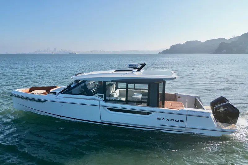 Slide: The Image of 2026 Saxdor 400 GTC luxury boat cruising on calm waters. - 13
