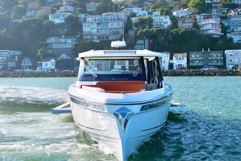 Slide: The Image of 2026 Saxdor 400 GTC boat cruising near coastal houses. - 14
