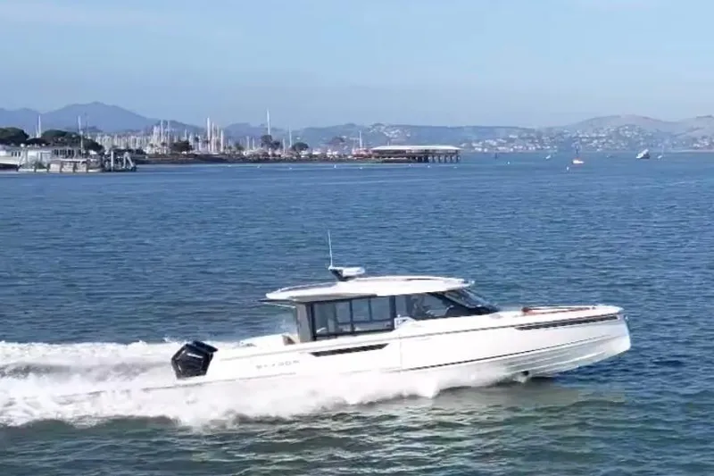 Slide: The Image of 2026 Saxdor 400 GTC cruising on a scenic coastal waterway. - 16