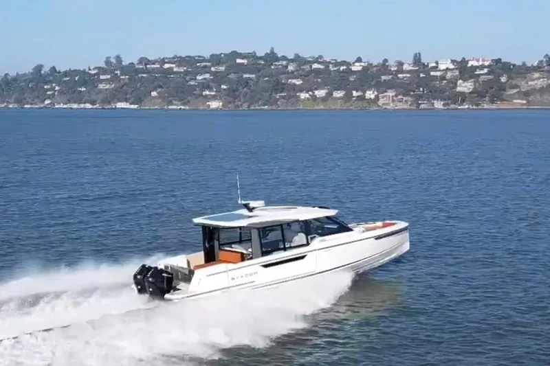Slide: The Image of 2026 Saxdor 400 GTC cruising on a scenic lake with distant shoreline views. - 17