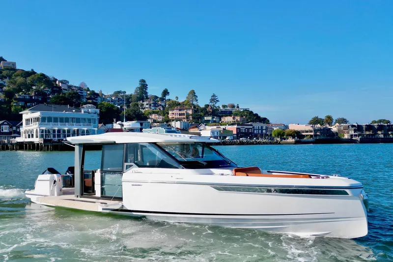 Slide: The Image of 2026 Saxdor 400 GTC yacht cruising near scenic waterfront homes. - 2