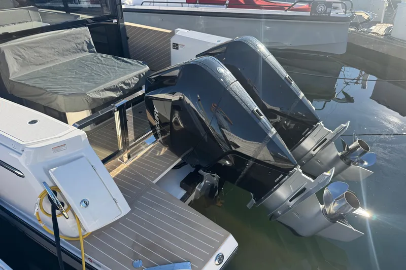 Slide: The Image of 2026 Saxdor 400 GTC boat with dual outboard motors docked in marina. - 23
