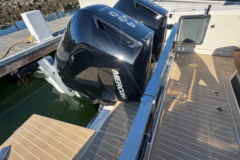 Slide: The Image of Saxdor 400 GTC 2026 boat with dual Mercury outboard engines at dock. - 24