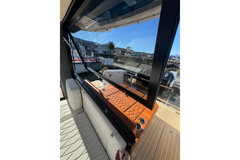 Slide: The Image of 2026 Saxdor 400 GTC yacht interior with luxurious seating and open window view. - 26
