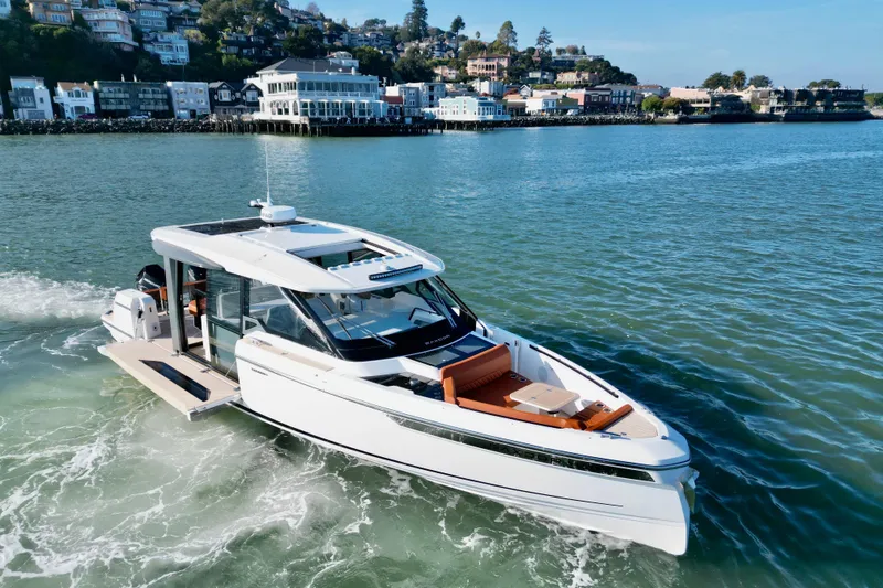 Slide: The Image of 2026 Saxdor 400 GTC luxury yacht cruising near scenic coastal town. - 3