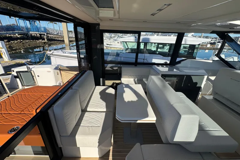 Slide: The Image of Interior of 2026 Saxdor 400 GTC yacht with modern seating and table arrangement. - 36
