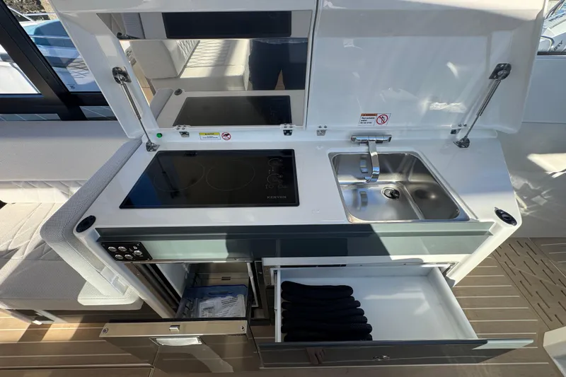 Slide: The Image of Modern kitchenette in 2026 Saxdor 400 GTC boat with stove, sink, and storage. - 41