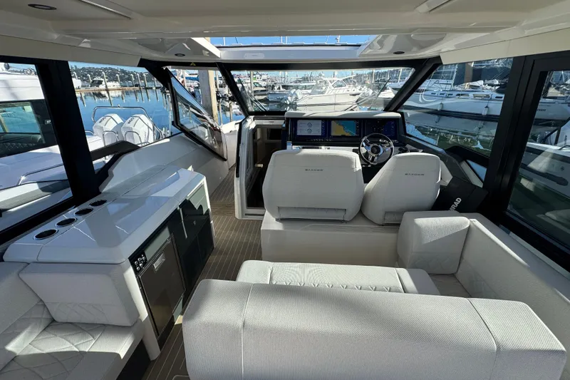 Slide: The Image of Interior of 2026 Saxdor 400 GTC yacht, featuring modern seating and navigation controls. - 42