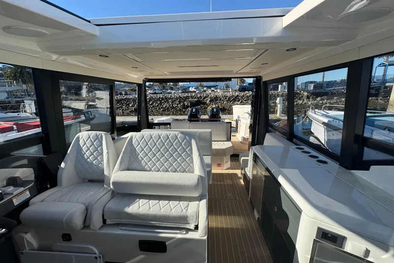 Slide: The Image of Interior of 2026 Saxdor 400 GTC boat with modern seating and sleek design. - 49
