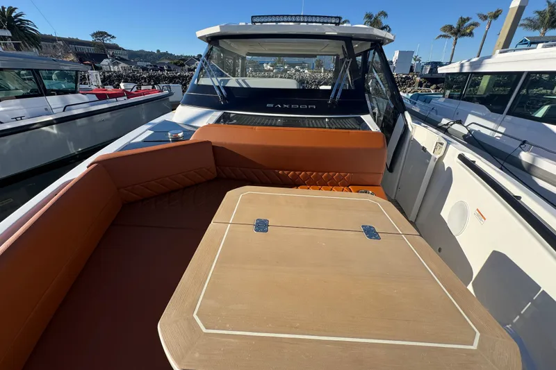 Slide: The Image of 2026 Saxdor 400 GTC boat interior with cushioned seating and wooden table. - 53