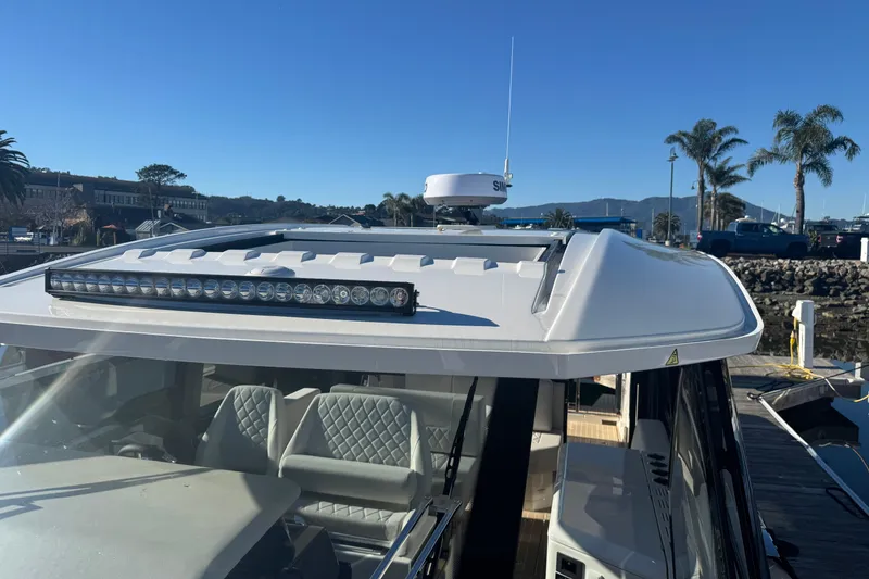 Slide: The Image of 2026 Saxdor 400 GTC boat with sleek design, docked under clear blue sky. - 56