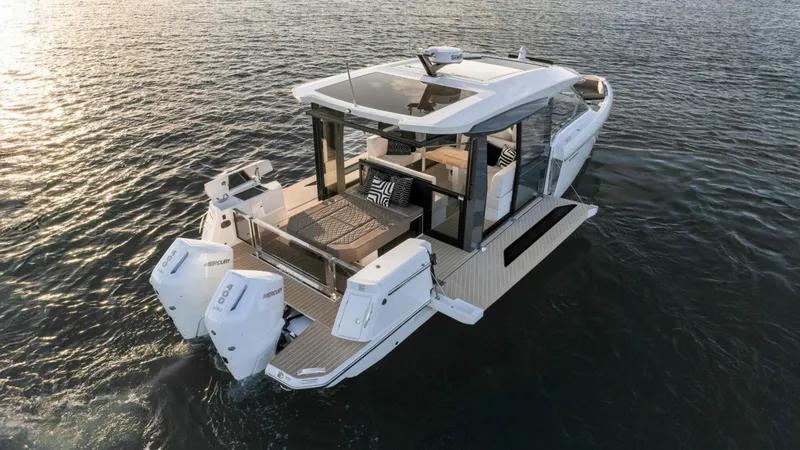 Slide: The Image of 2025 Saxdor 400 GTC luxury boat on water, featuring sleek design and dual outboard engines. - 57