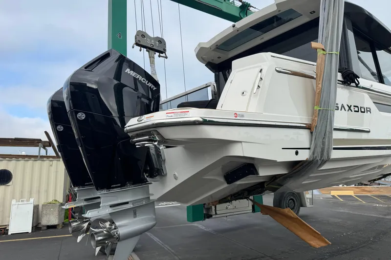 Slide: The Image of 2026 Saxdor 400 GTC boat with Mercury outboard engine in a shipyard. - 58